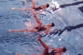 three Swarthmore synchronized swimmers performing in the pool